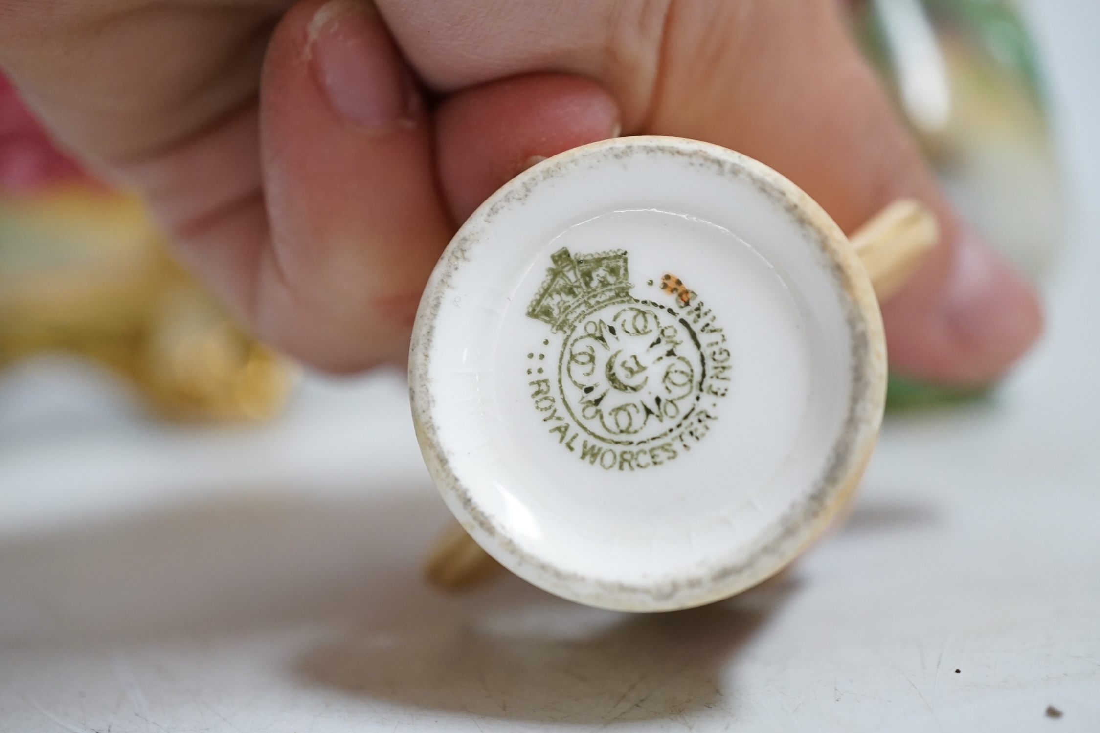 A Royal Worcester floral painted, twin handled dish, painted by Ethel Spilsbury, together with a miniature Worcester blush mug and a Hadley Worcester vase, dish 23.5cm wide. Condition - poor-fair